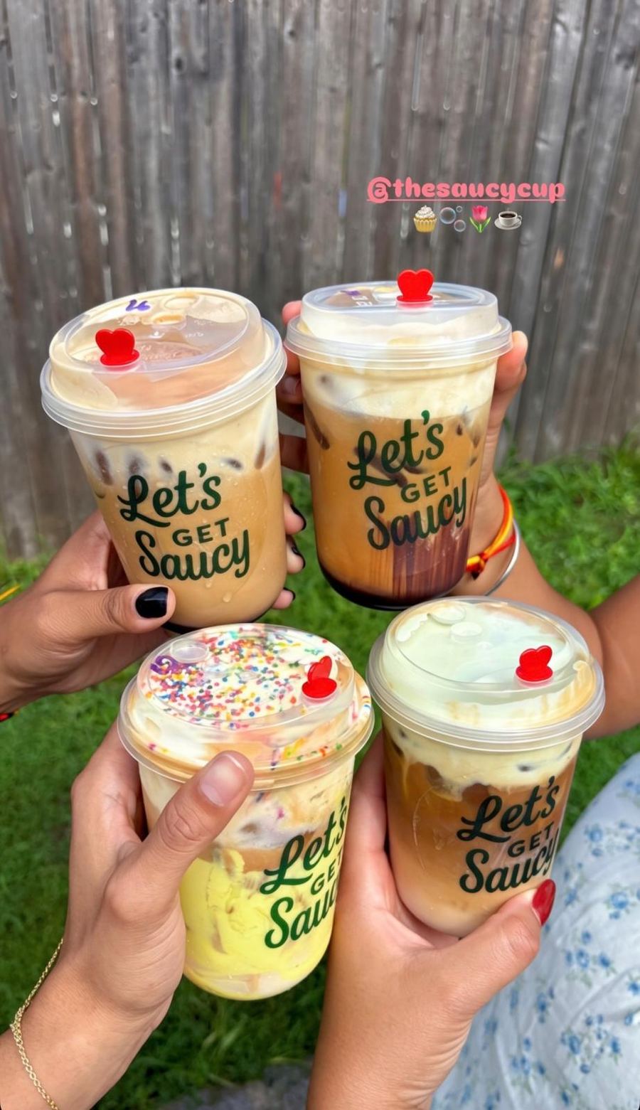 Friends cheersing with Let's Get Saucy iced drinks