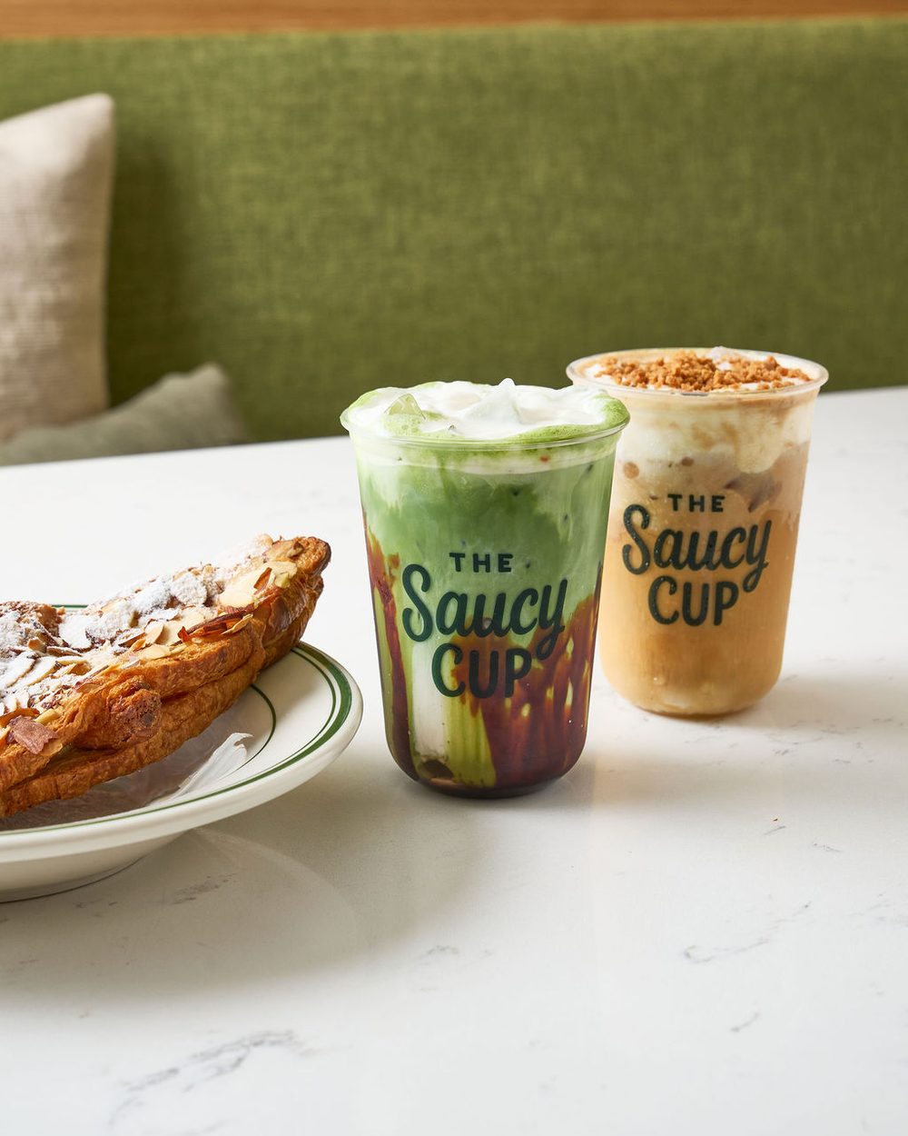 Almond croissant with an iced matcha and a Latte Biscotto