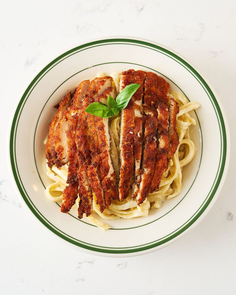 Fettuccine alfredo pasta bowl with chicken cutlet
